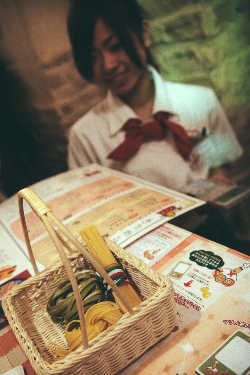A waitress with a basket of pasta
