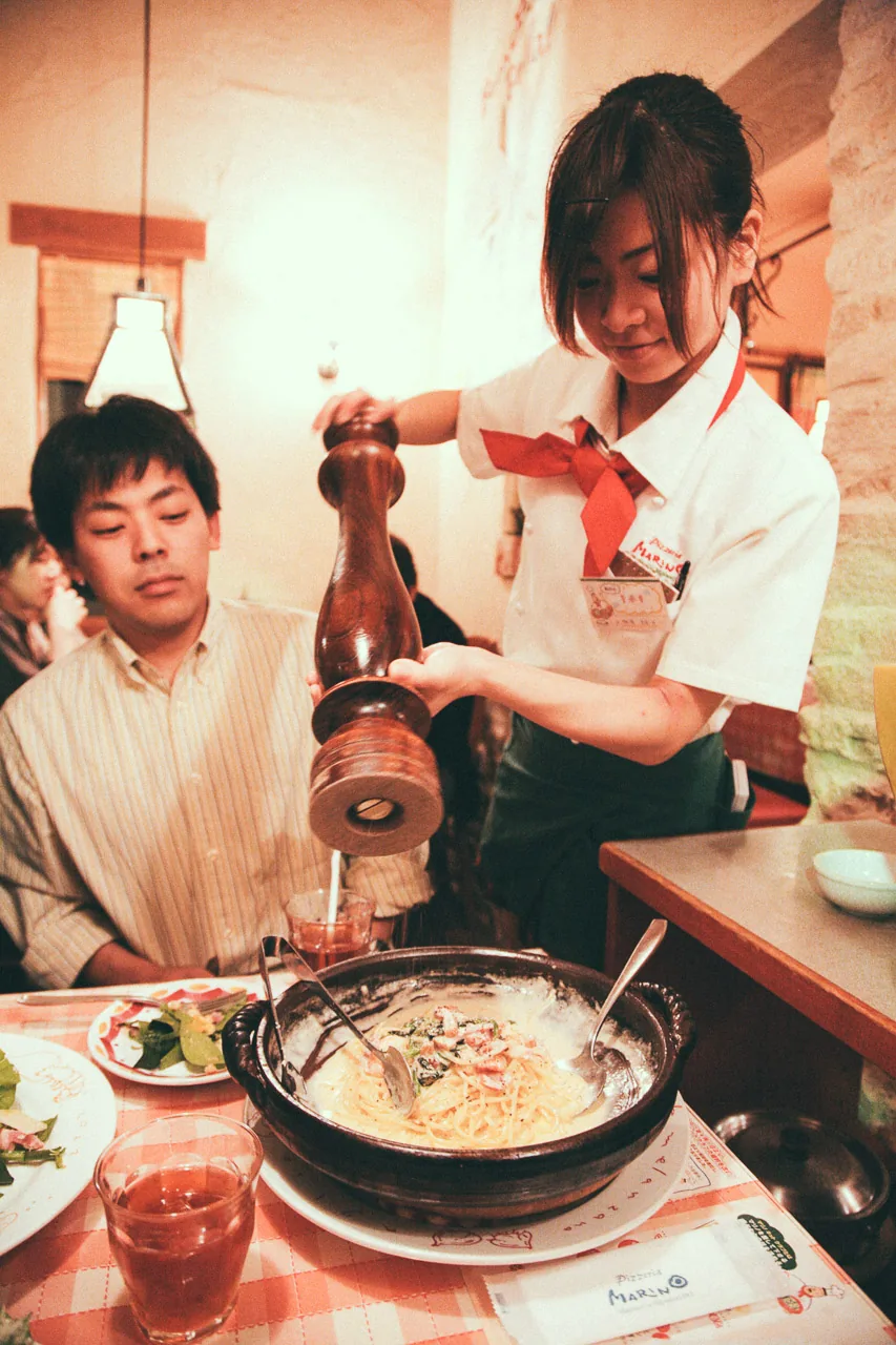 Grinding pepper over the pasta