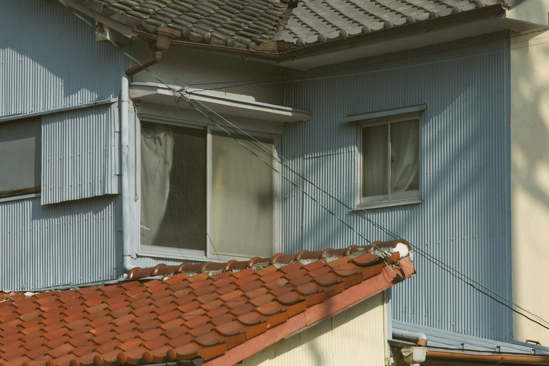 A window above a red tiled roof