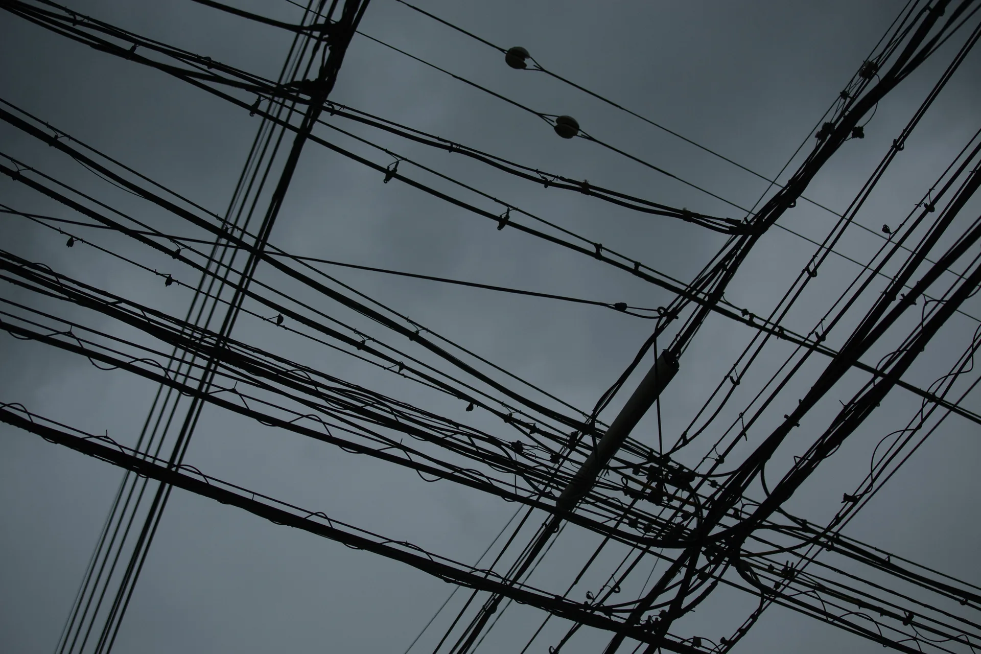 Power lines crossing a dark sky