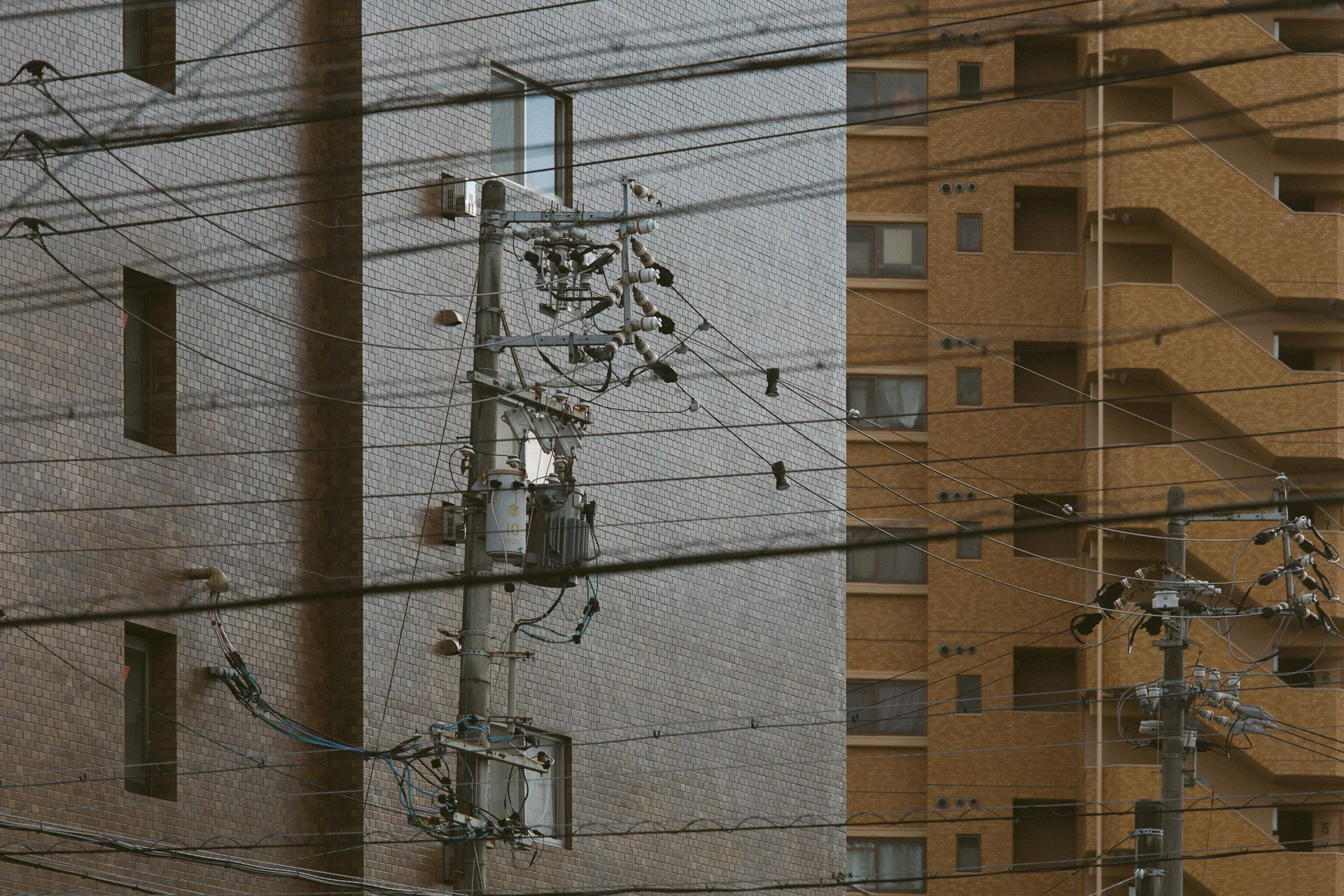White and orange buildings crossed by wires