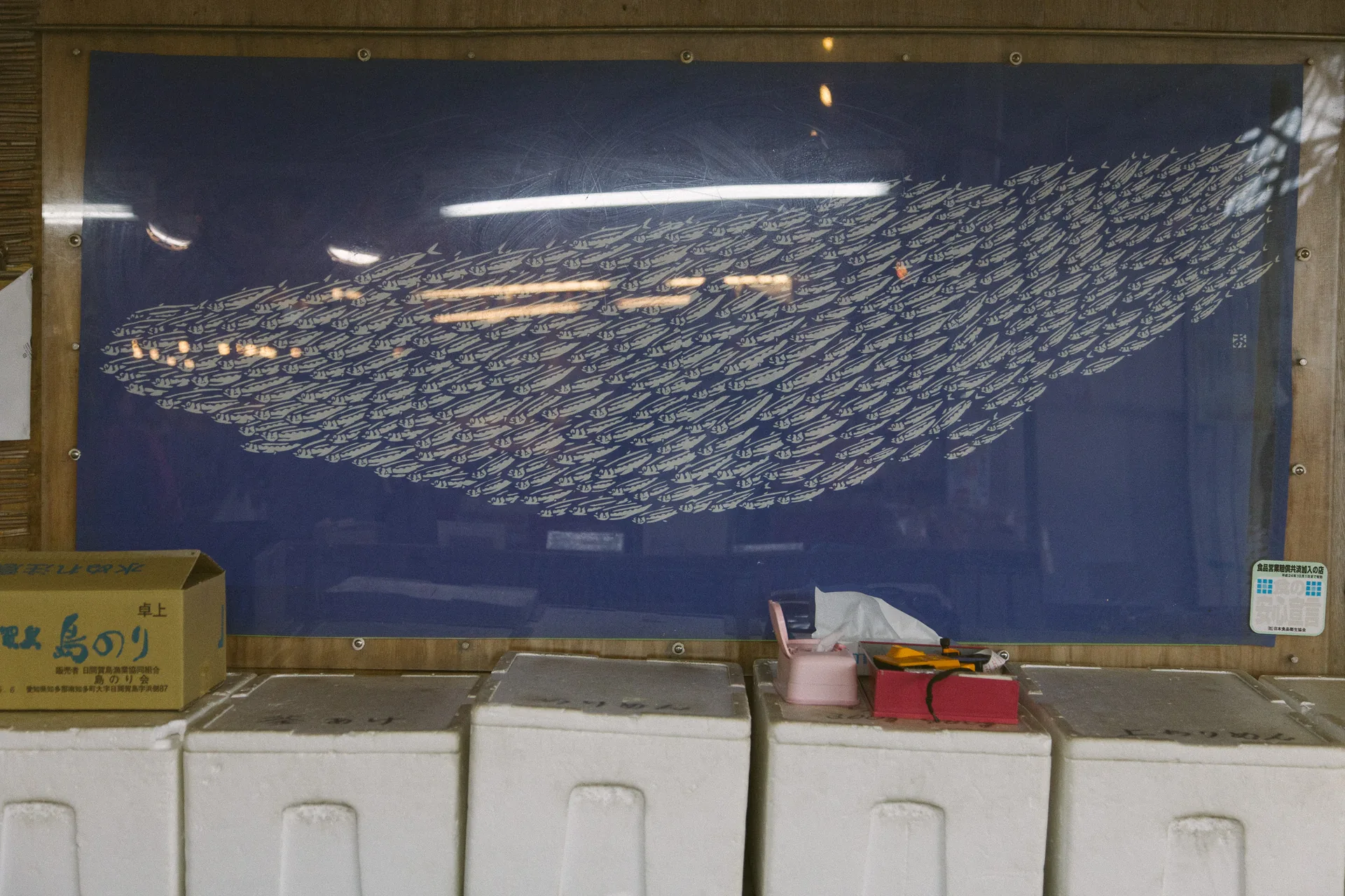 A painted whale over stacked crates