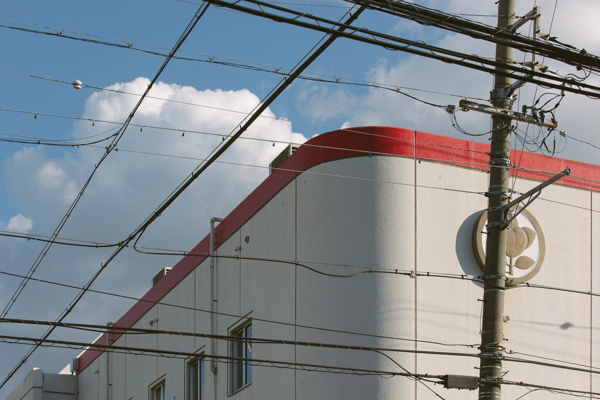 A storefront sign crossed by wires