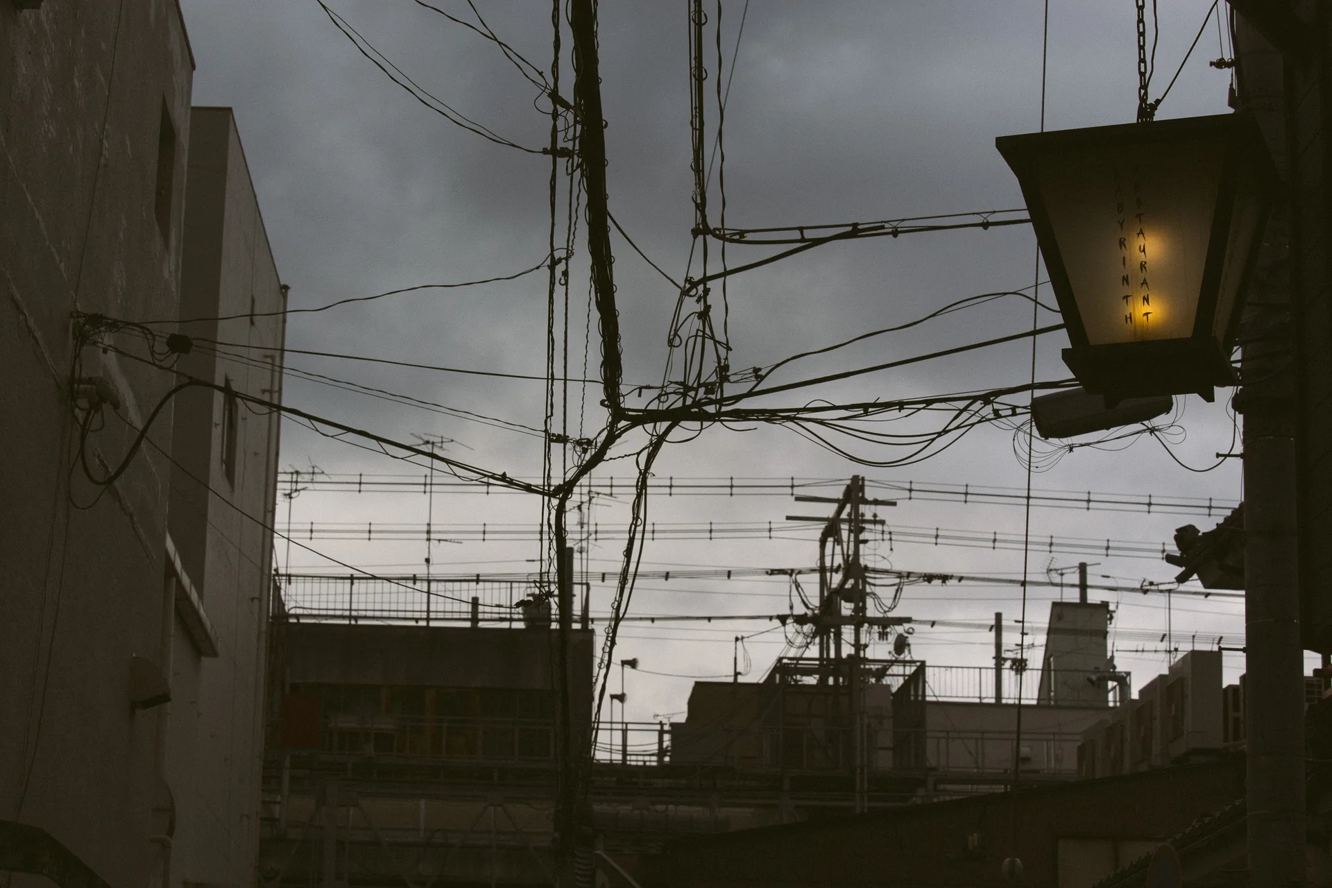 A street lamp and wires in silhouette