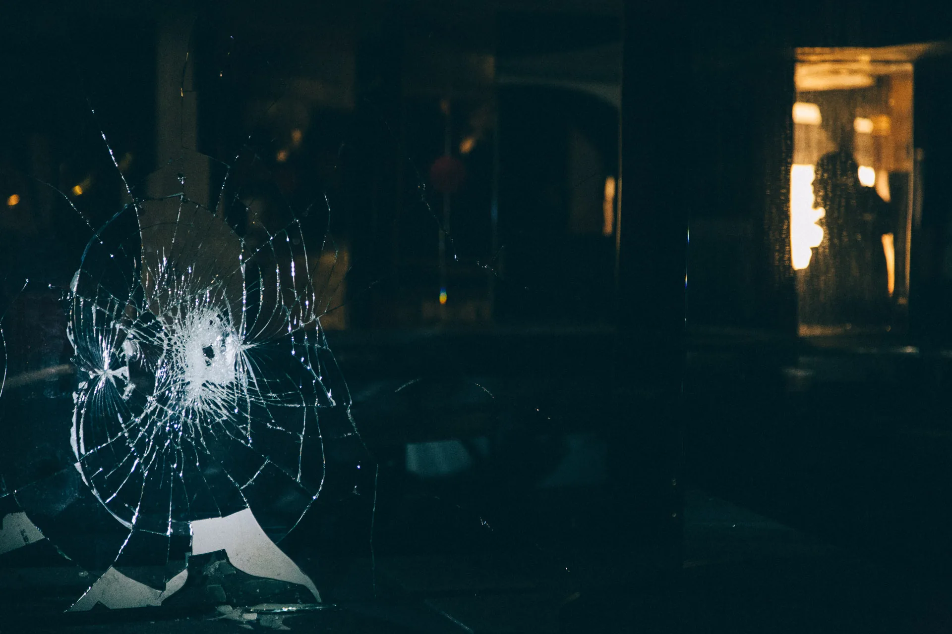 A shattered glass panel in the dark
