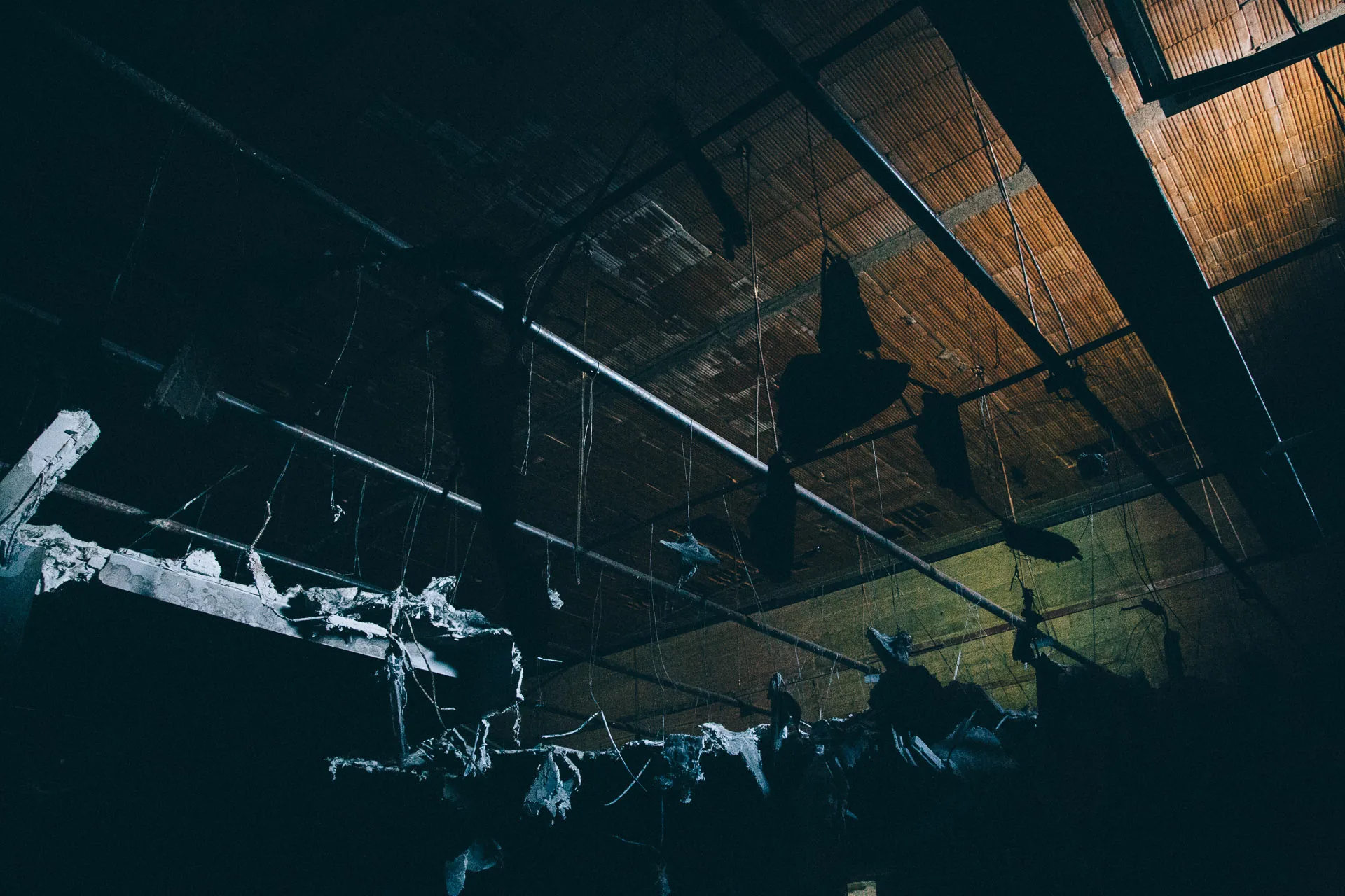 Light catching the debris of a collapsed ceiling