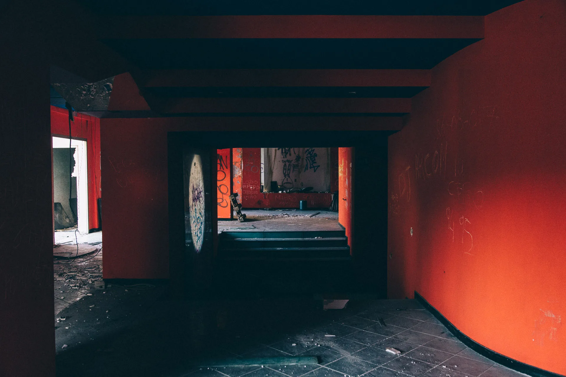 A long red corridor under a low dark ceiling