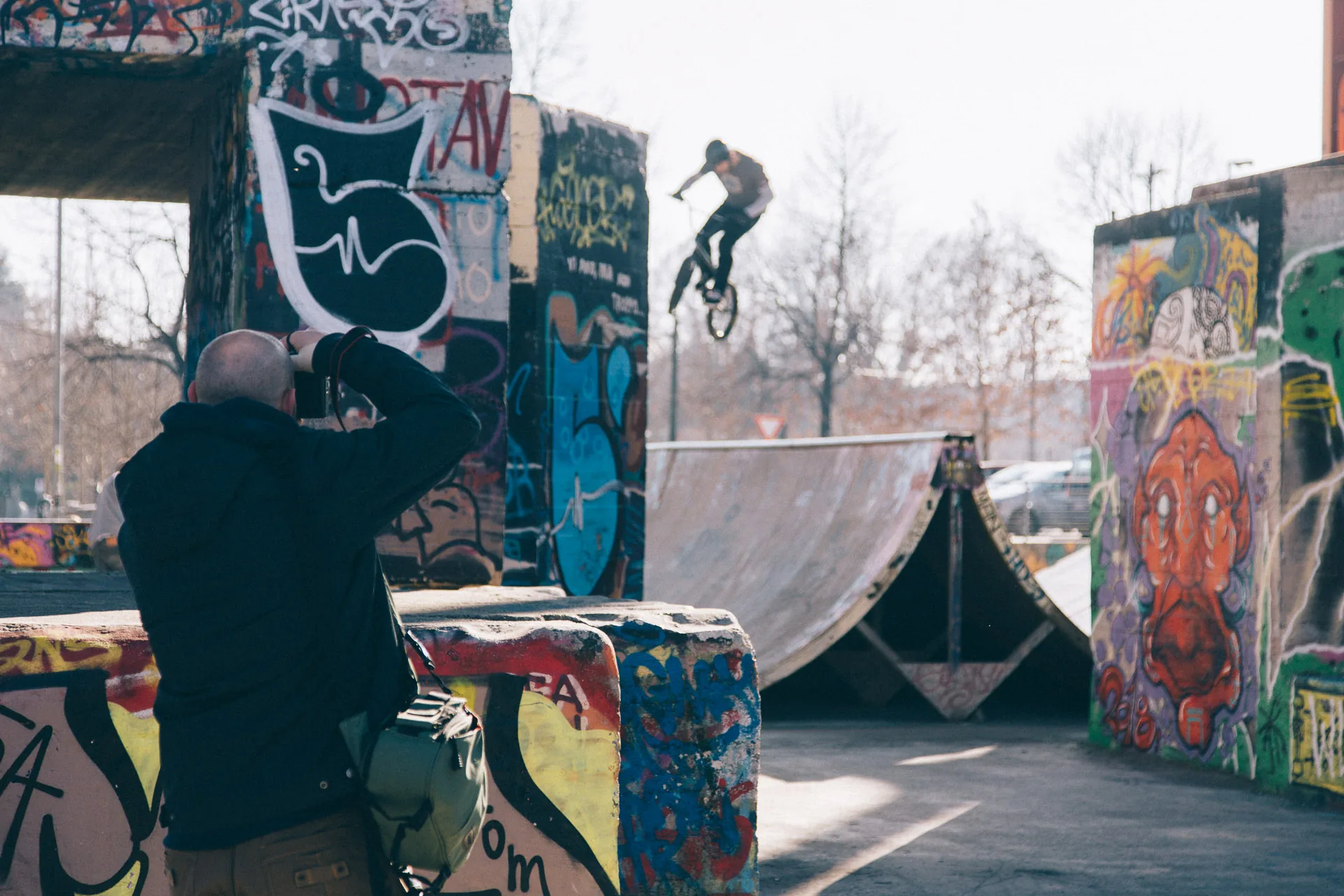 A friend photographing a skate park covered in graffiti