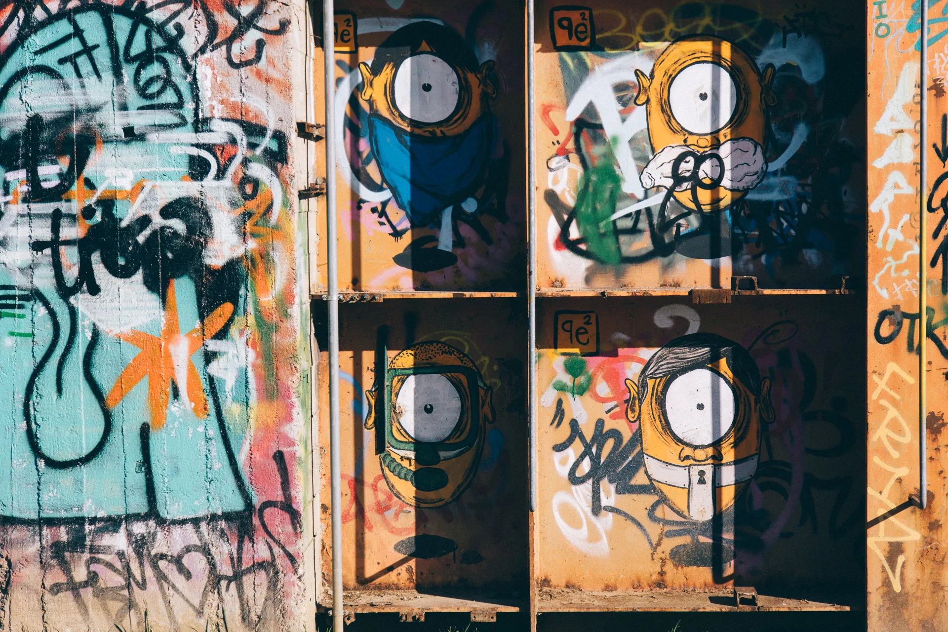 Graffiti-covered panels on rusted steel frames